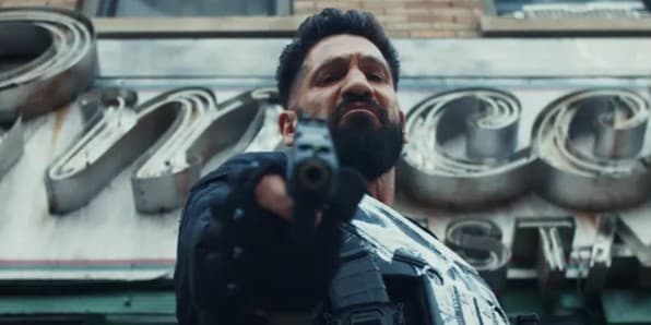 Daredevil: Born Again promotional image showing Daredevil in a red suit against a city backdrop.