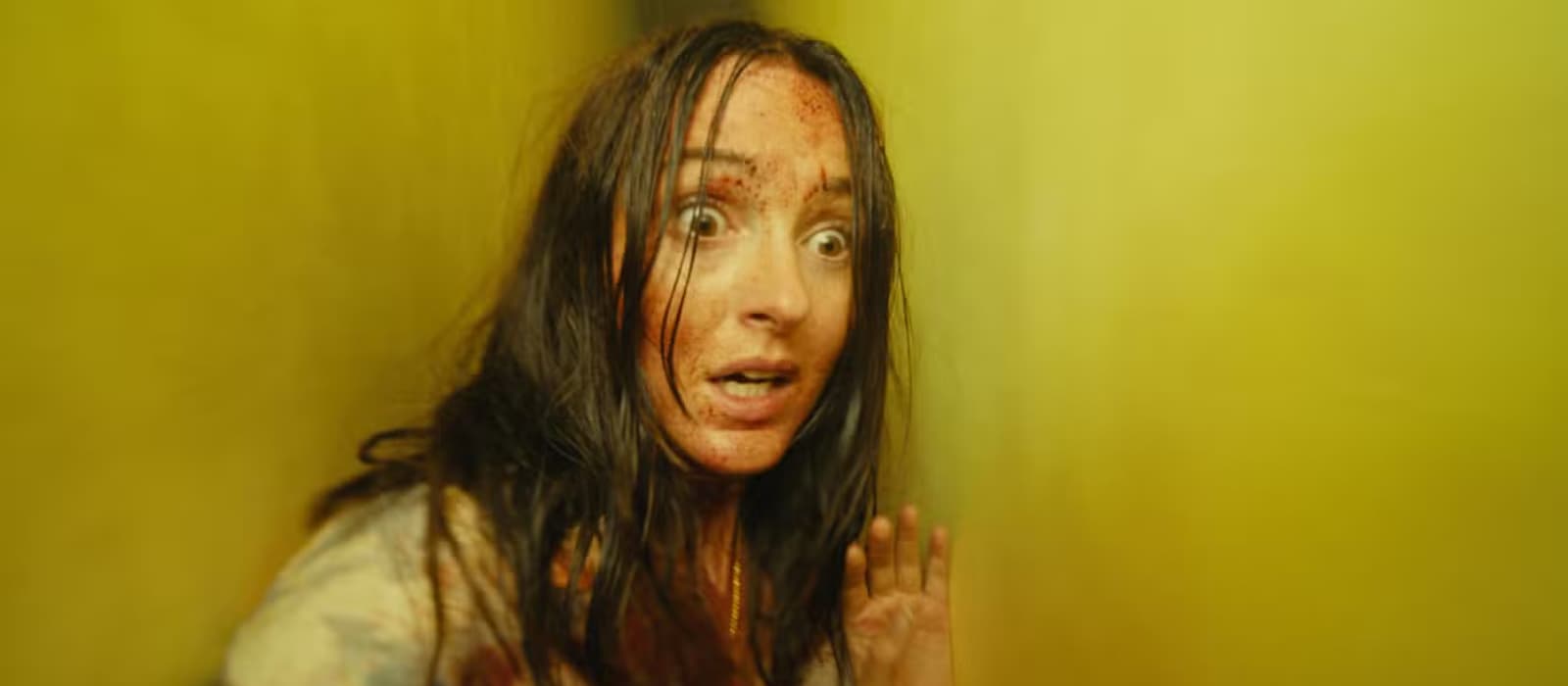 renate-reinsve-running-through-a-tight-hallway-with-blood-on-her-face-in-backrooms-v1.png