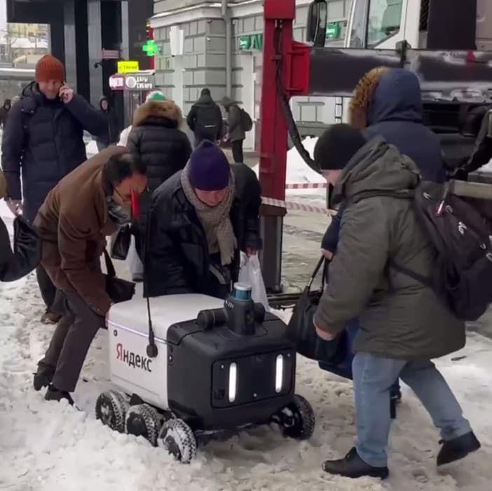 Passersby help a robot courier