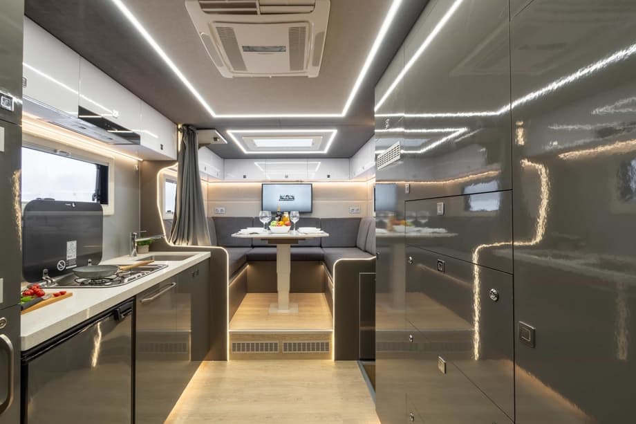 Кухонная зона оборудована большим количеством встроенных шкафчиков во всю стену для удобного хранения