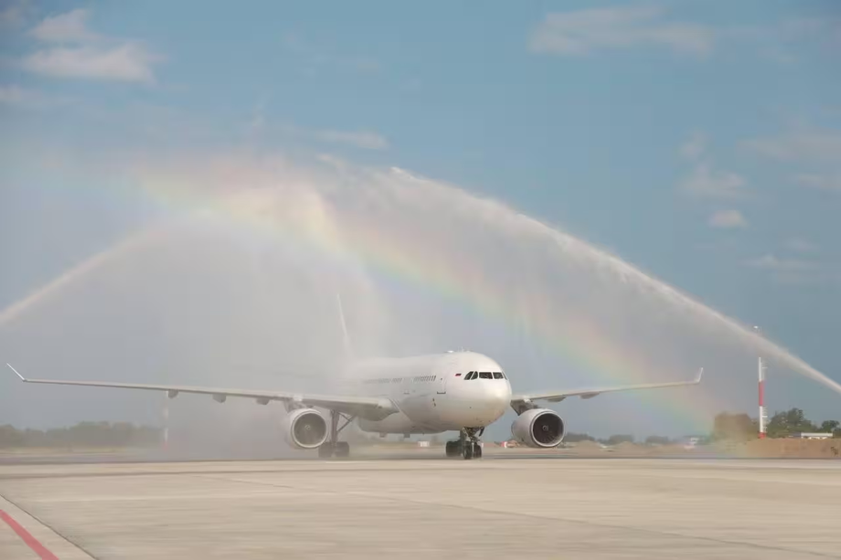 Airplane under a water arch