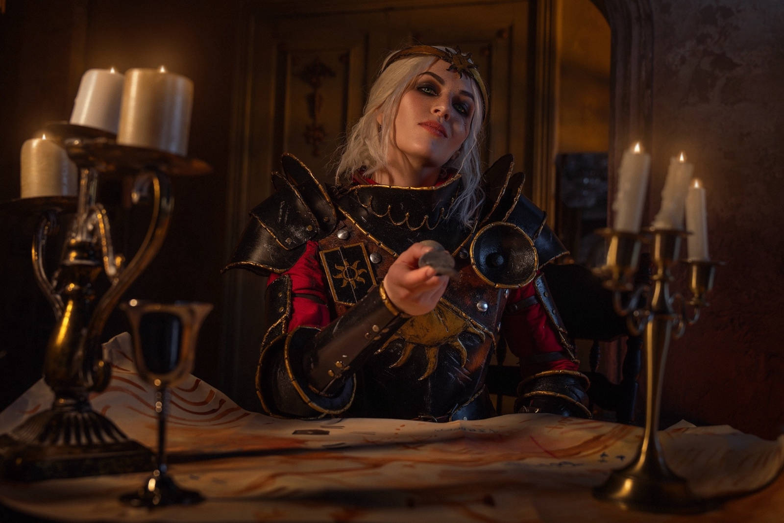 Empress Ciri cosplay in a commanding stance, with one hand resting on her sword.